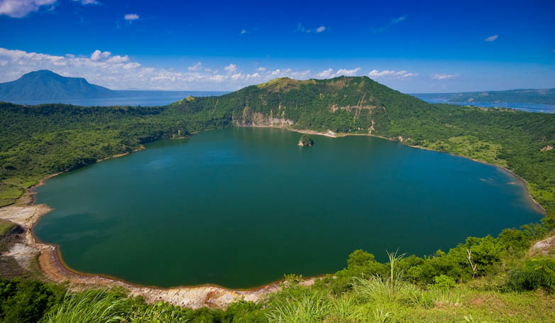 Close-up view of Taal volcano with beautiful landscape and green lake.