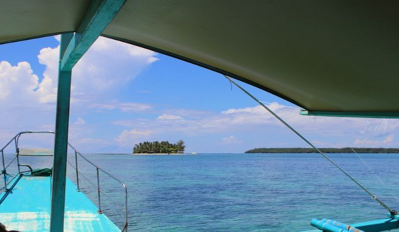 Beautiful view of crystal-clear water from the boat on the Siargao Island